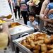 Amir Reyes, 5, watches employees plate food at the Shalimar tent during the Taste of Ann Arbor on Sunday, June 2. Daniel Brenner I AnnArbor.com